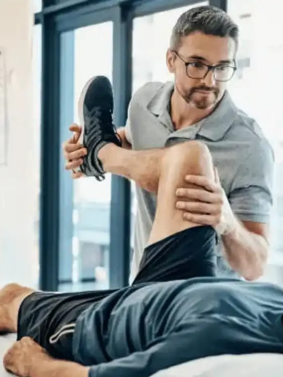A physical therapist assessing a patient's knee range of motion at Empower Physical Therapy & Aquatics Institute in Ladera Ranch, CA